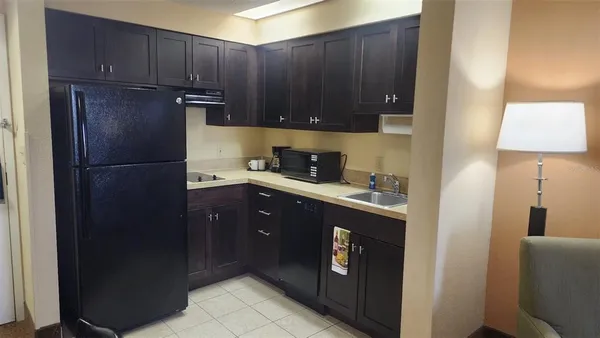 a kitchen with a refrigerator and cabinets