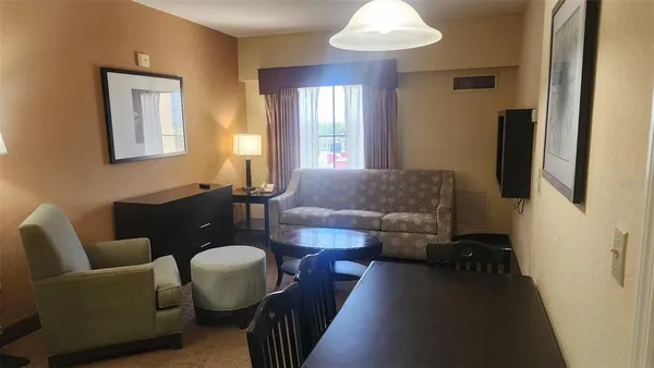 a living room with furniture and a chandelier