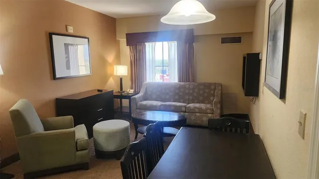 a living room with furniture and a chandelier