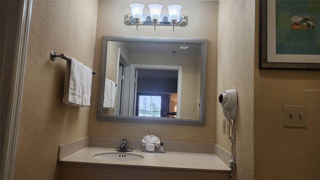 7601 Canada Avenue, Unit 618 Orlando, FL 32819 - Photo 10 of 19 a bathroom with a sink and a mirror