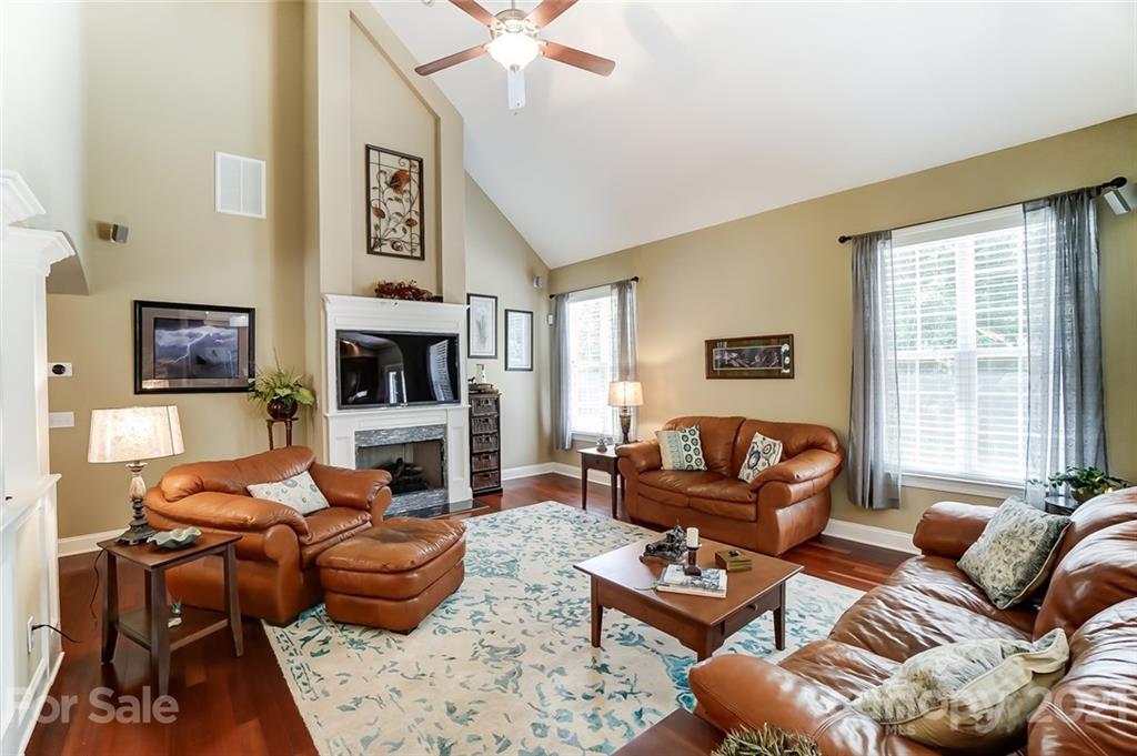 1100 Blacksnake Road Stanley, NC 28164 - Photo 11 of 48 a living room with furniture flat screen tv and a fireplace