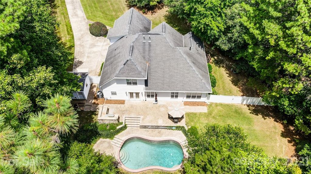 1100 Blacksnake Road Stanley, NC 28164 - Photo 3 of 48 an aerial view of a house with swimming pool and large trees