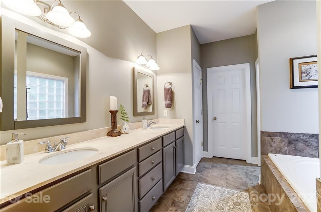 1100 Blacksnake Road Stanley, NC 28164 - Photo 22 of 48 a bathroom with a tub a sink and mirror