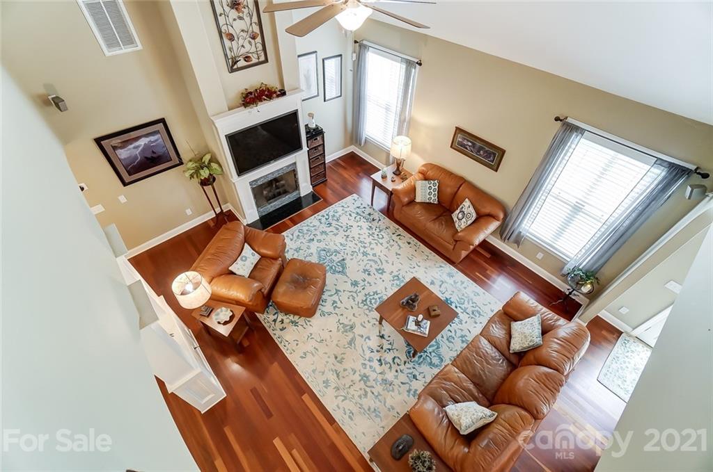 1100 Blacksnake Road Stanley, NC 28164 - Photo 25 of 48 a living room with furniture rug and a fireplace