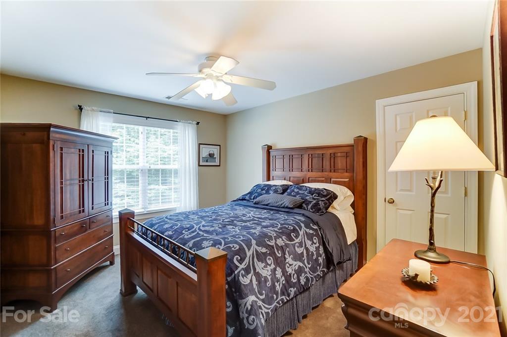 1100 Blacksnake Road Stanley, NC 28164 - Photo 26 of 48 a bedroom with a bed and wooden floor