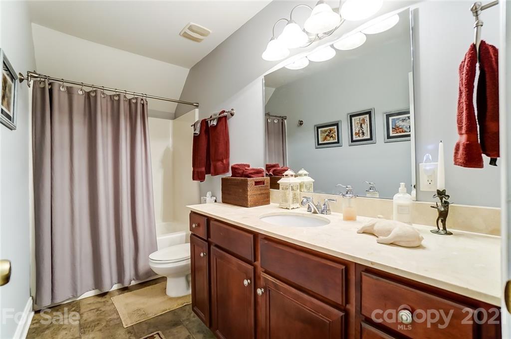 1100 Blacksnake Road Stanley, NC 28164 - Photo 29 of 48 a bathroom with a double vanity sink and a mirror
