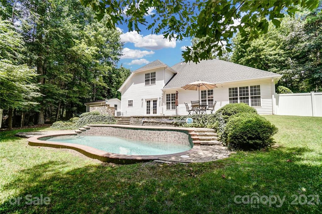 1100 Blacksnake Road Stanley, NC 28164 - Photo 36 of 48 a view of a house with a yard and sitting area