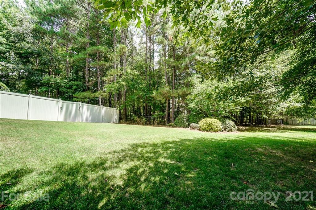 1100 Blacksnake Road Stanley, NC 28164 - Photo 43 of 48 a view of a yard with a house and large trees