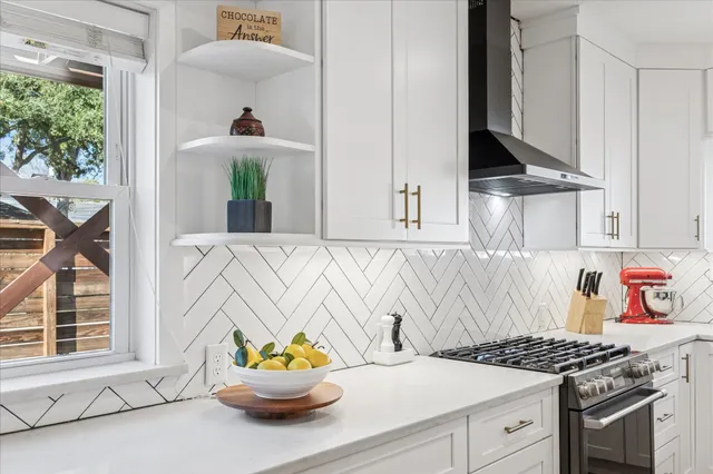 a open kitchen with stainless steel appliances granite countertop a sink dishwasher and a stove with wooden floor