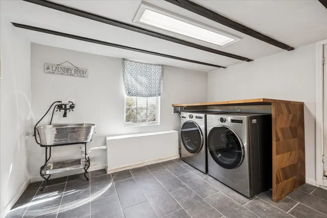 a bathroom with a granite countertop sink a mirror and a shower