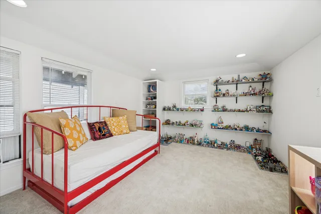 a bedroom with furniture and wooden floor