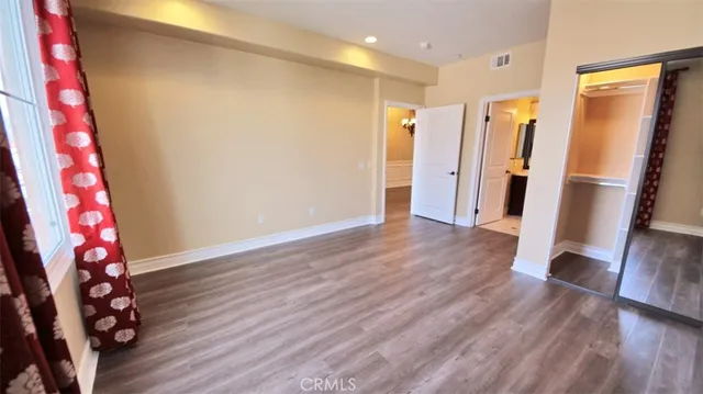 a view of hallway with wooden floor and stairs