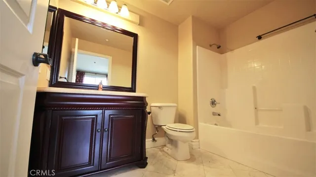 a bathroom with a toilet a sink and a mirror