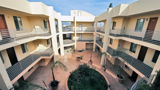 a view of a patio with couches chairs and potted plants