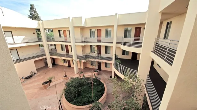 a view of a balcony with wooden floor and more windows