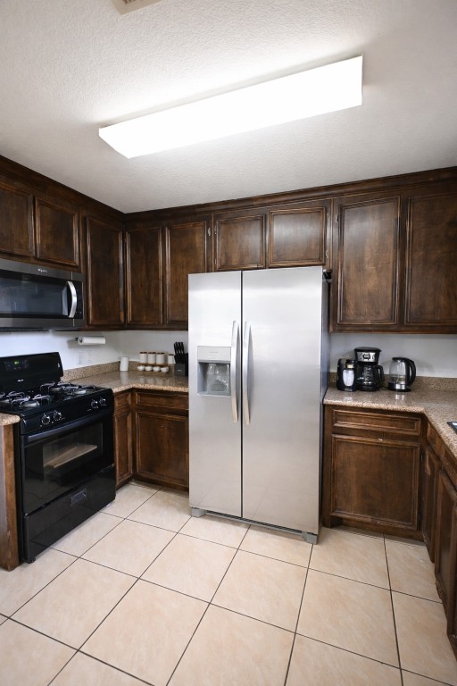 250 7th Street Hempstead, TX 77445 - Photo 11 of 26 a kitchen with stainless steel appliances granite countertop a stove a refrigerator and a sink