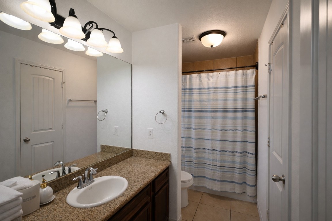 250 7th Street Hempstead, TX 77445 - Photo 14 of 26 a bathroom with a sink vanity granite and a mirror