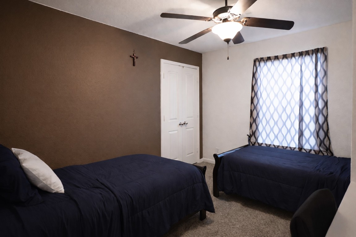 250 7th Street Hempstead, TX 77445 - Photo 15 of 26 a bedroom with a bed and a chandelier
