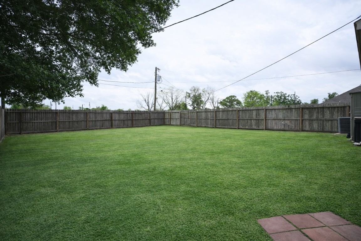 250 7th Street Hempstead, TX 77445 - Photo 24 of 26 a view of yard with green space and wooden fence