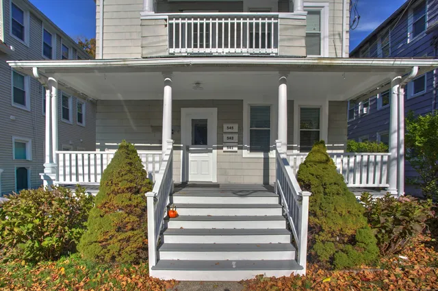 a front view of a house with a garden
