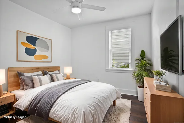 a bedroom with bed and a flat screen tv