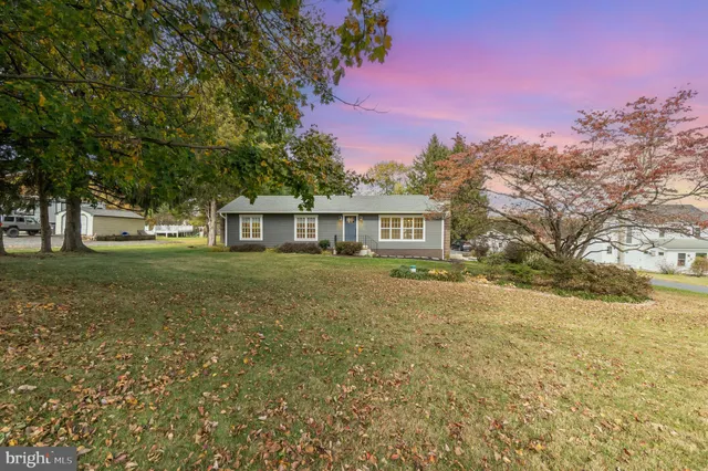 a front view of house with yard and trees