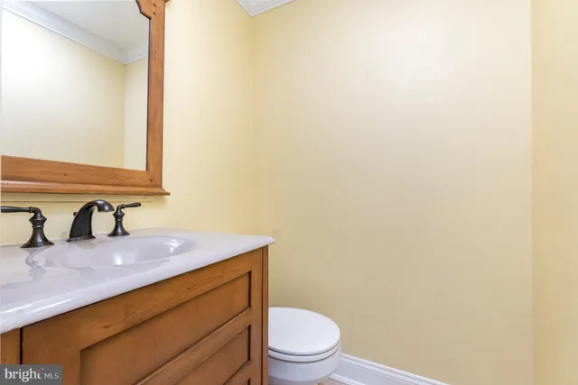 a bathroom with a sink a toilet and mirror