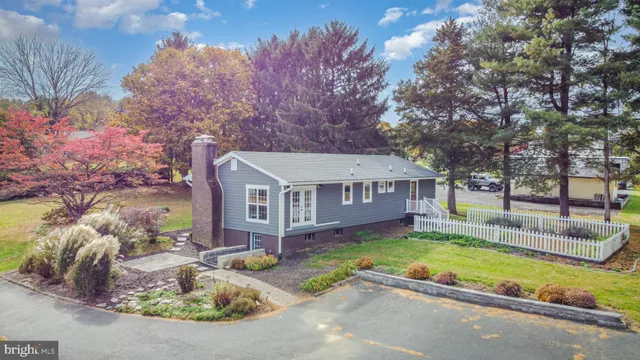 an aerial view of a house with a yard and lake view