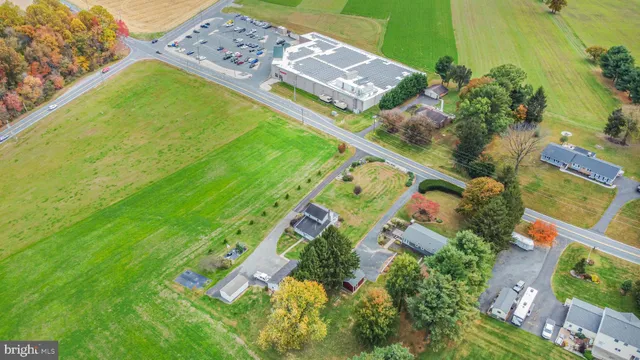 an aerial view of residential houses with outdoor space and street view