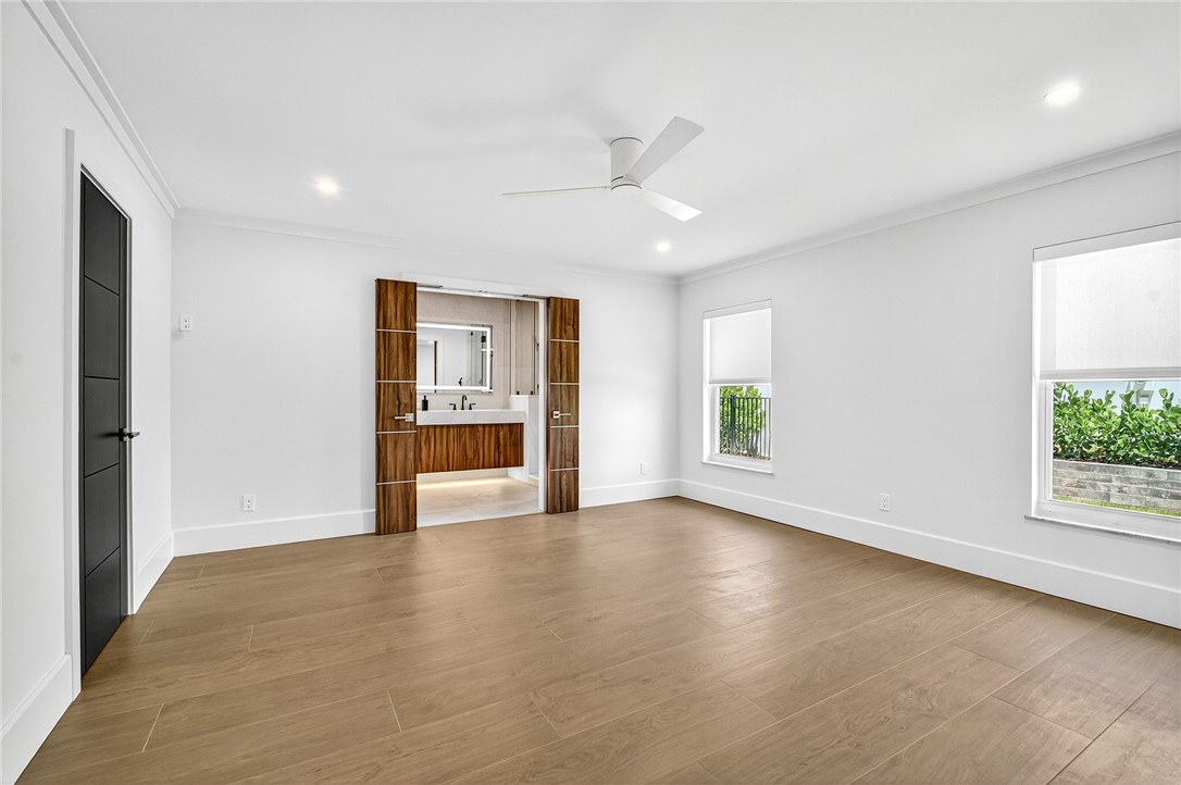 661 Date Palm Road Vero Beach, FL 32963 - Photo 15 of 34 a view of an empty room with a window and wooden floor