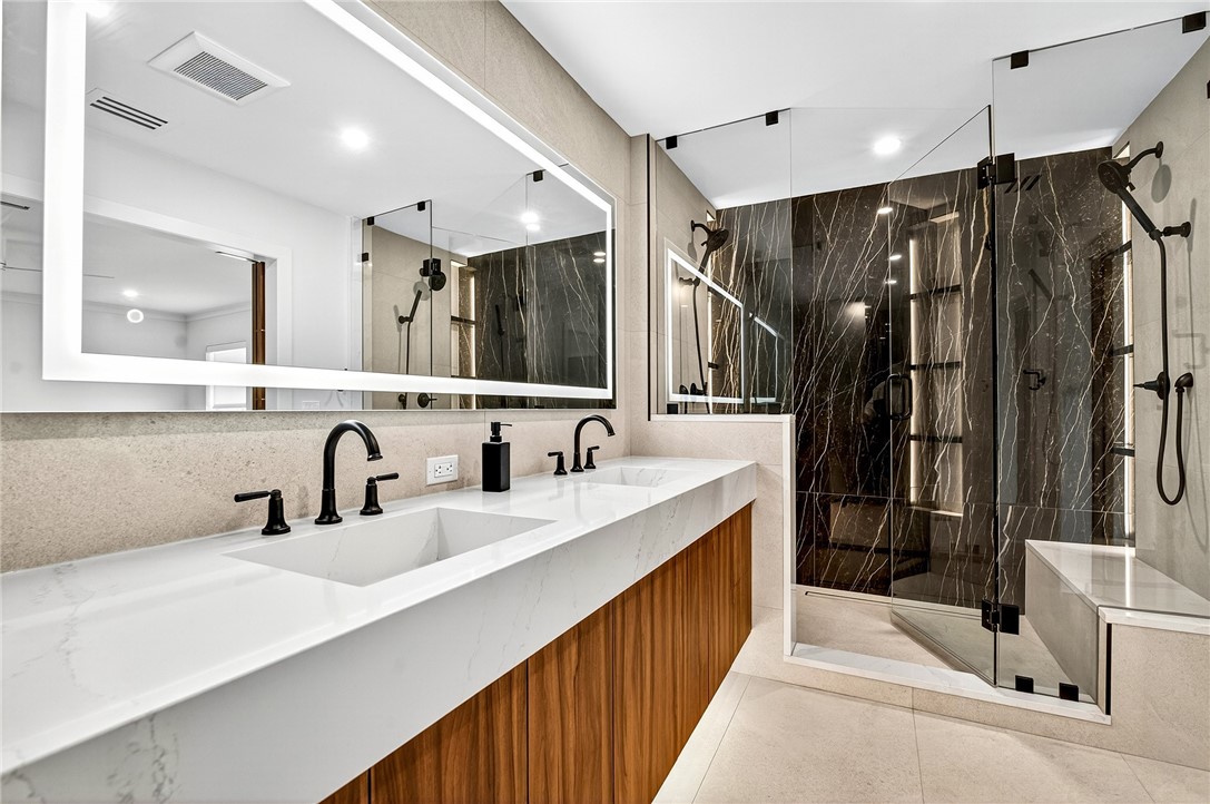 661 Date Palm Road Vero Beach, FL 32963 - Photo 18 of 34 a bathroom with a double sink shower and a mirror