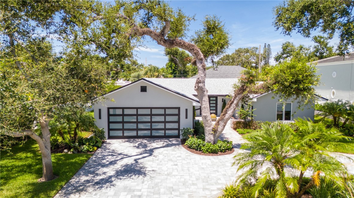 661 Date Palm Road Vero Beach, FL 32963 - Photo 33 of 34 a front view of a house with a yard and garage