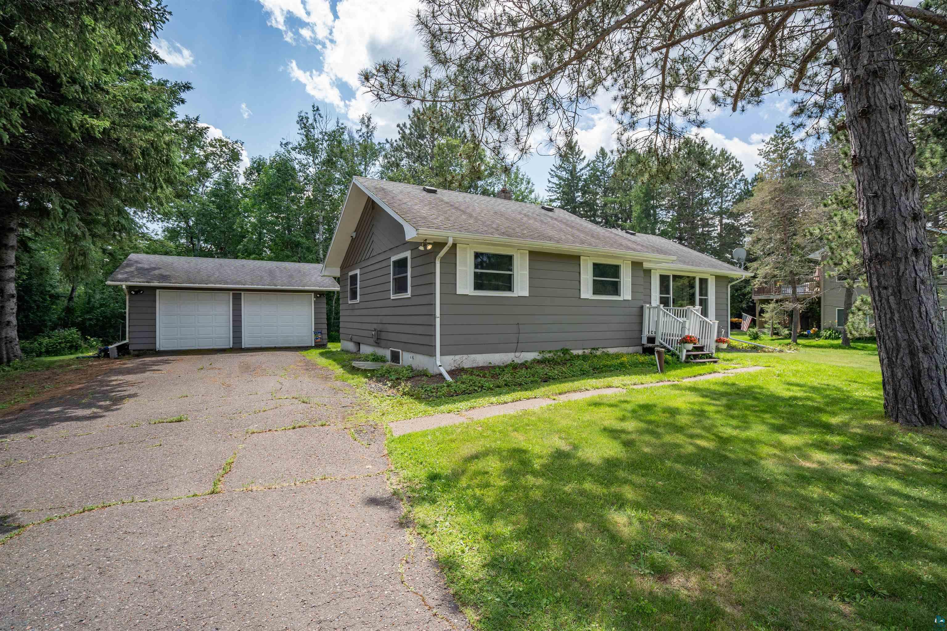 View of front facade with a garage and a front lawn