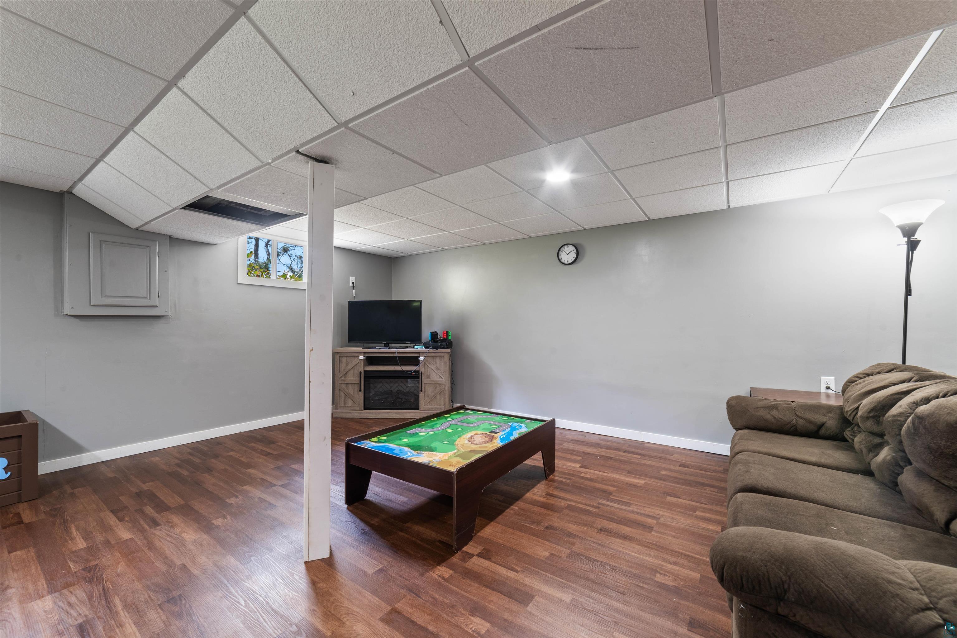 5716 North Pike Lake Road Duluth, MN 55811 - Photo 21 of 31 Rec room with a paneled ceiling and dark hardwood / wood-style flooring