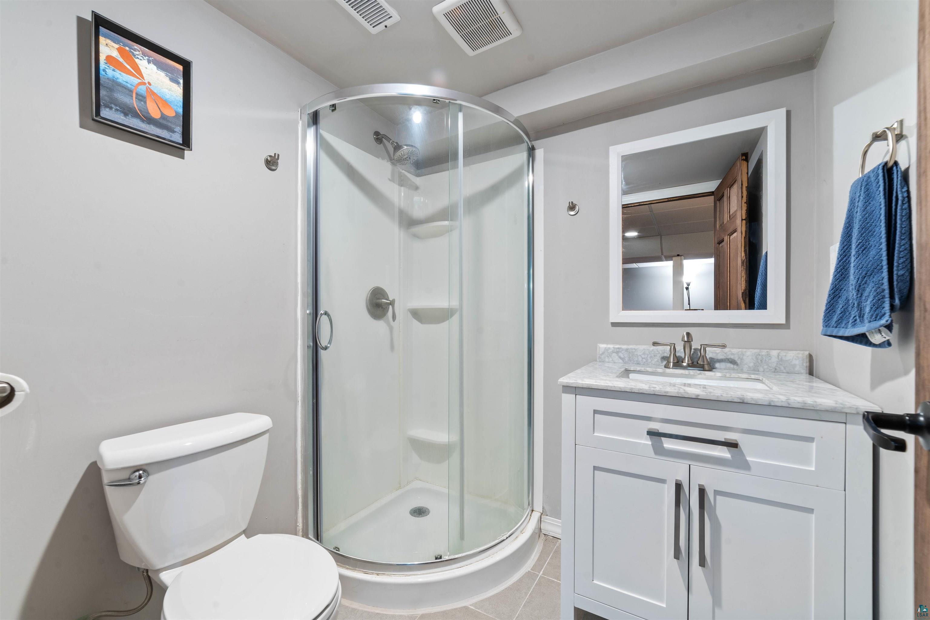 5716 North Pike Lake Road Duluth, MN 55811 - Photo 23 of 31 Bathroom with a shower with door, toilet, and vanity