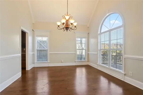 a view of wooden floor and chandelier in a room