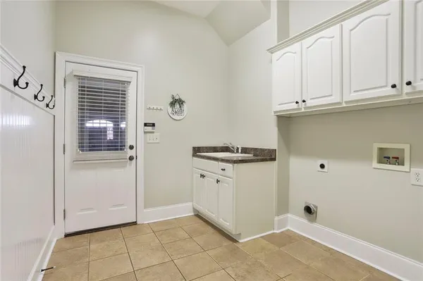 a kitchen with white cabinets and white appliances