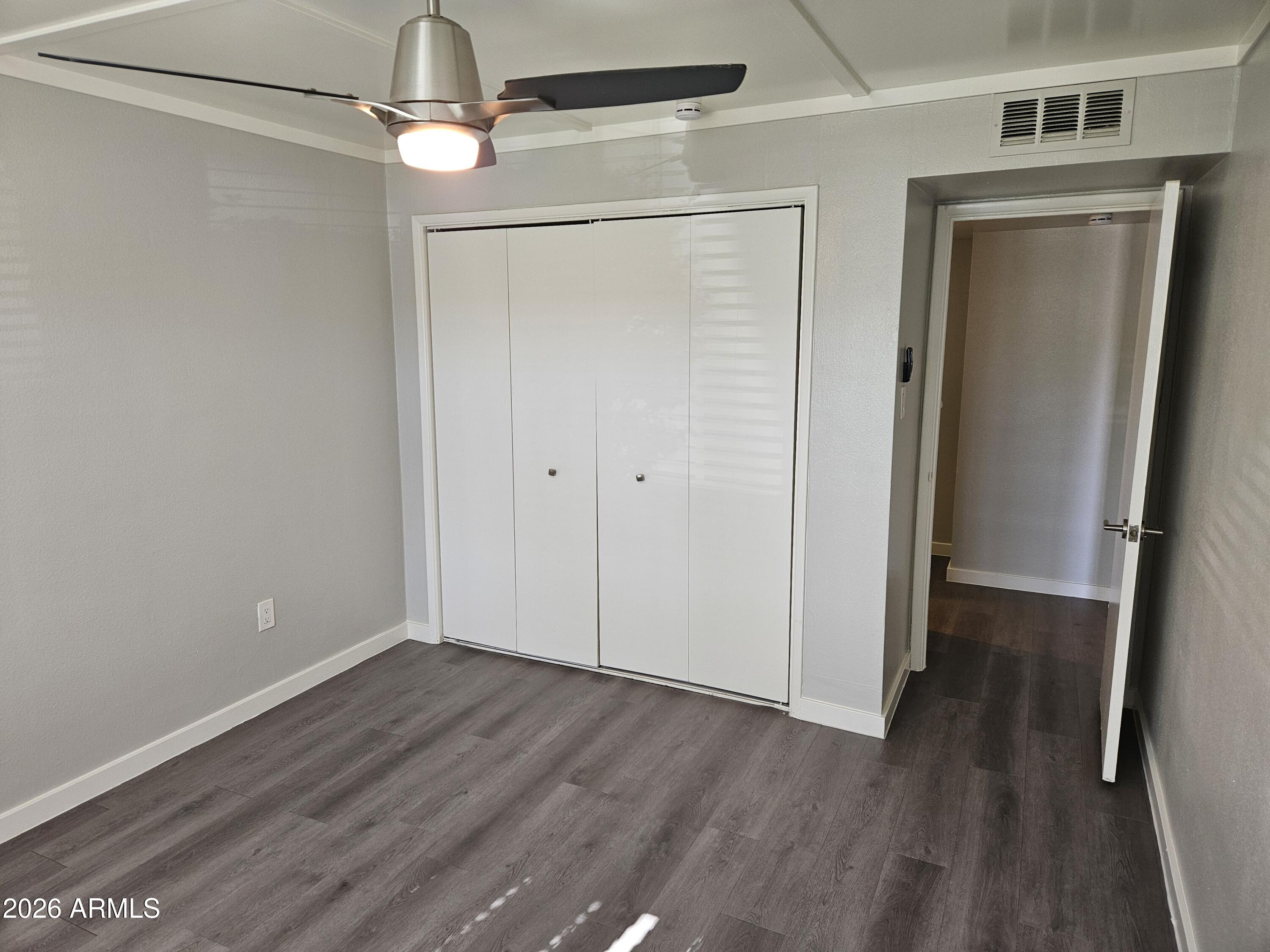 324 West Pasadena Avenue, Unit 8 Phoenix, AZ 85013 - Photo 11 of 22 a view of an empty room with wooden floor