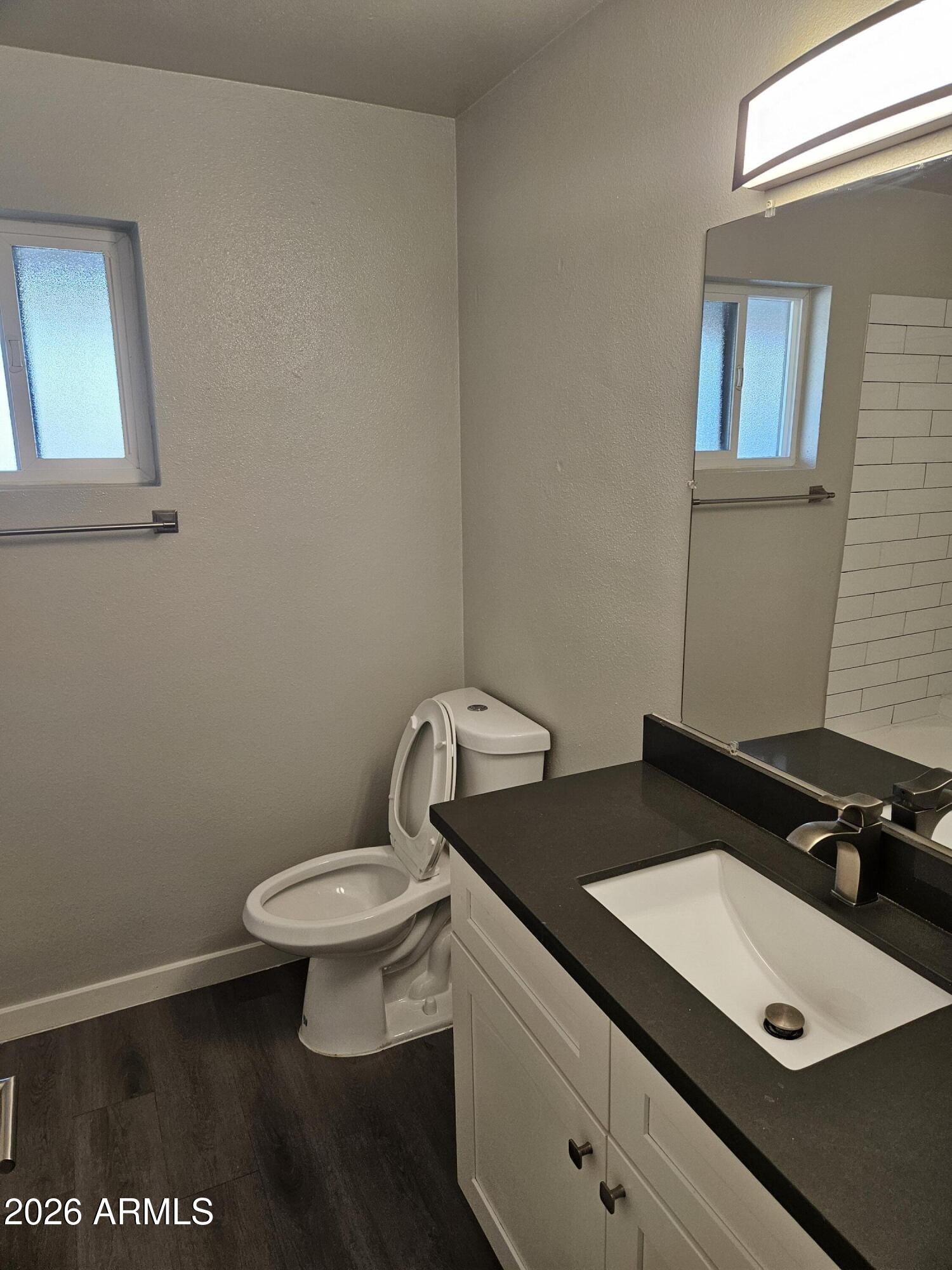 324 West Pasadena Avenue, Unit 8 Phoenix, AZ 85013 - Photo 16 of 22 a bathroom with a sink and a toilet