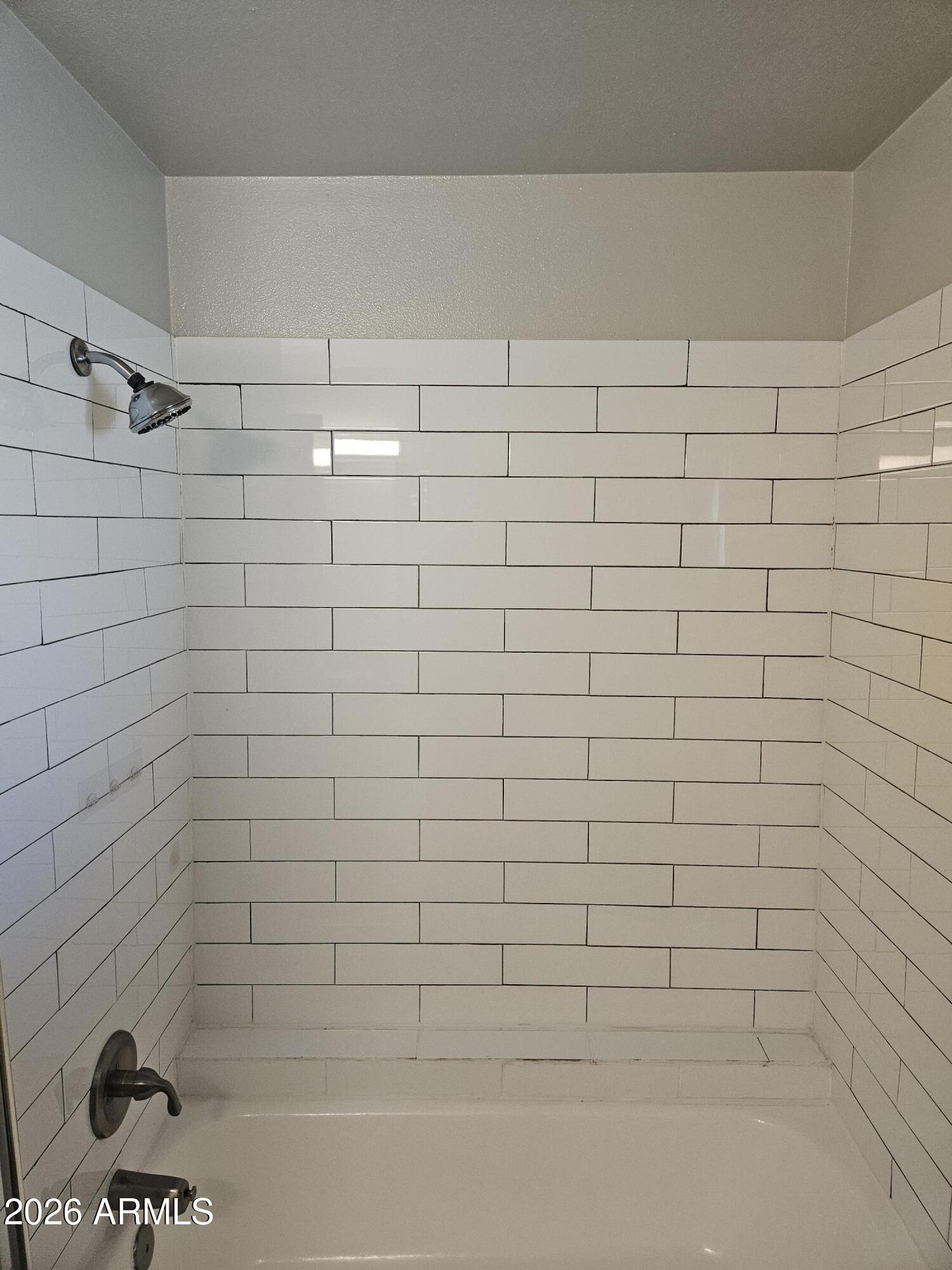 324 West Pasadena Avenue, Unit 8 Phoenix, AZ 85013 - Photo 17 of 22 a bathroom with a shower and a bathtub