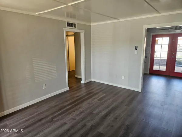 a view of a room with wooden floor and a window