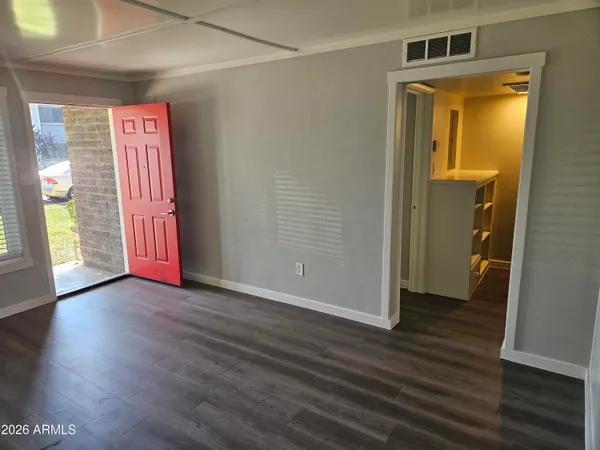a view of front door with wooden floor and stairs