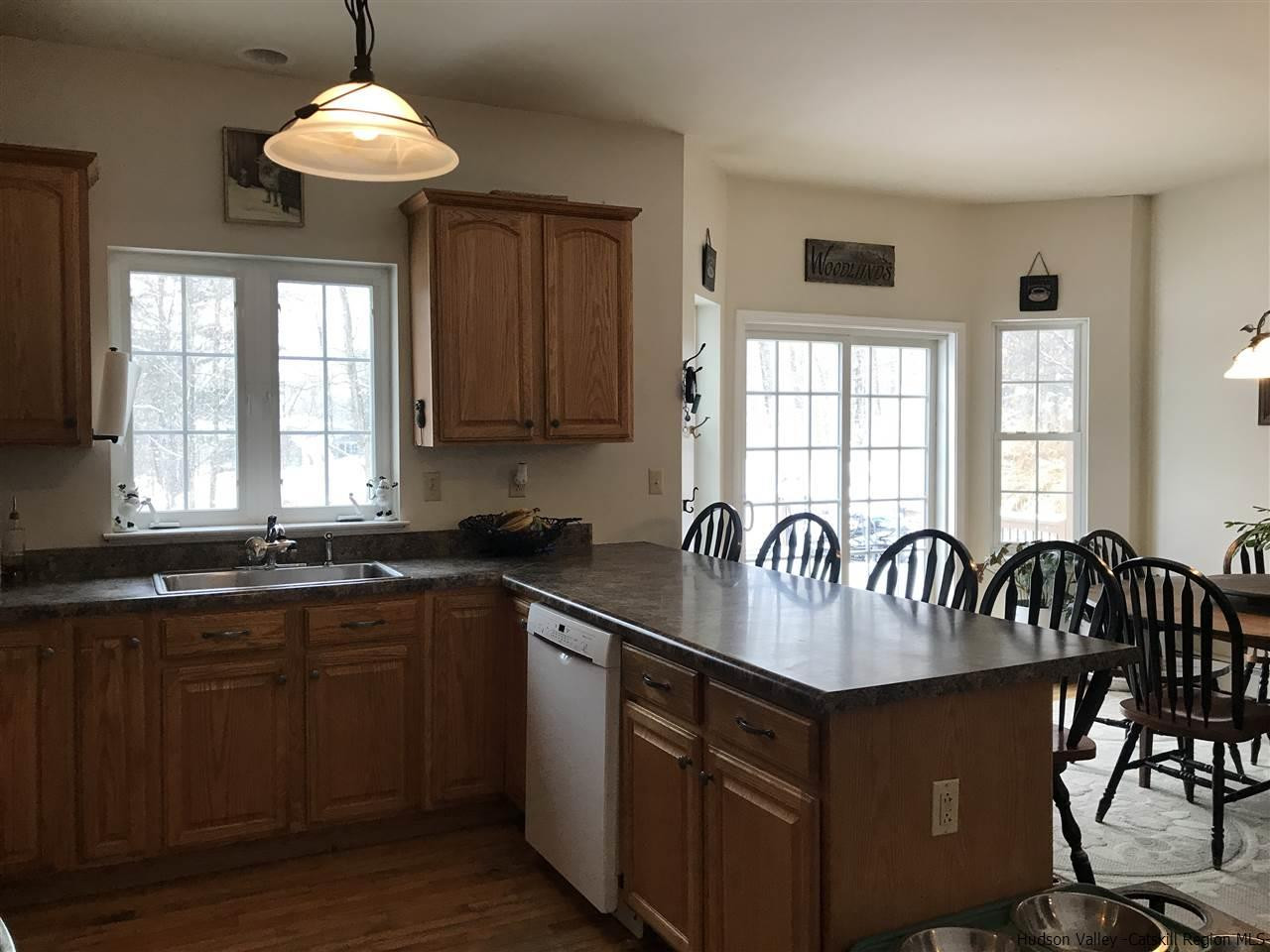 31 Camp Ridge Road Wallkill, NY 12589 - Photo 14 of 35 a kitchen with granite countertop a stove a sink a dining table and chairs