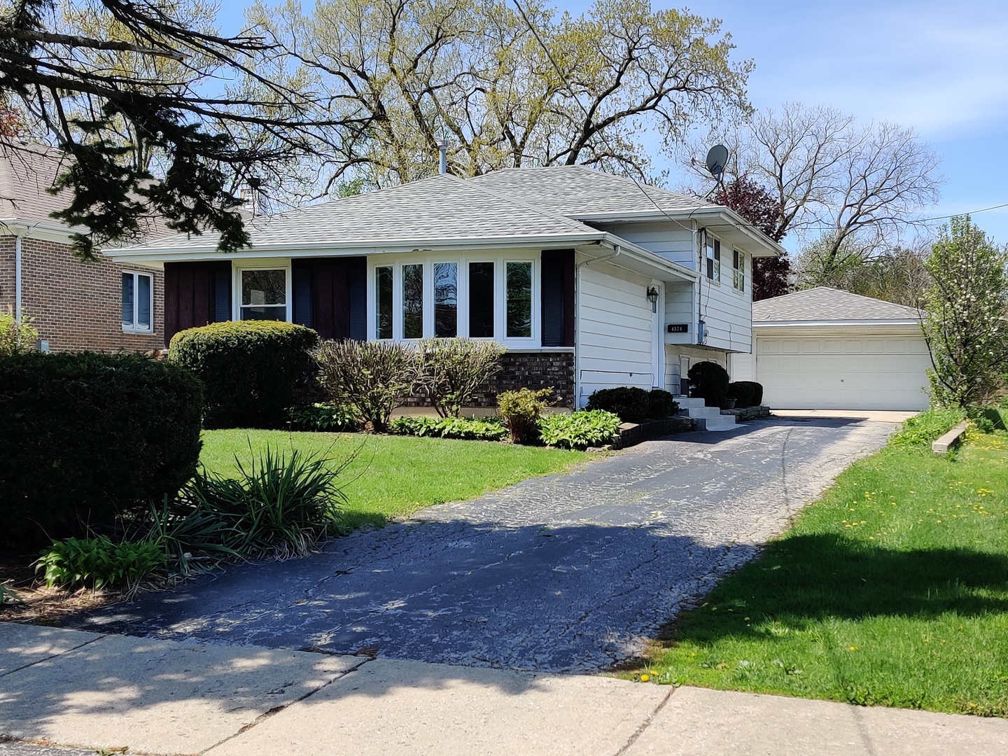a front view of a house with a yard and outdoor seating