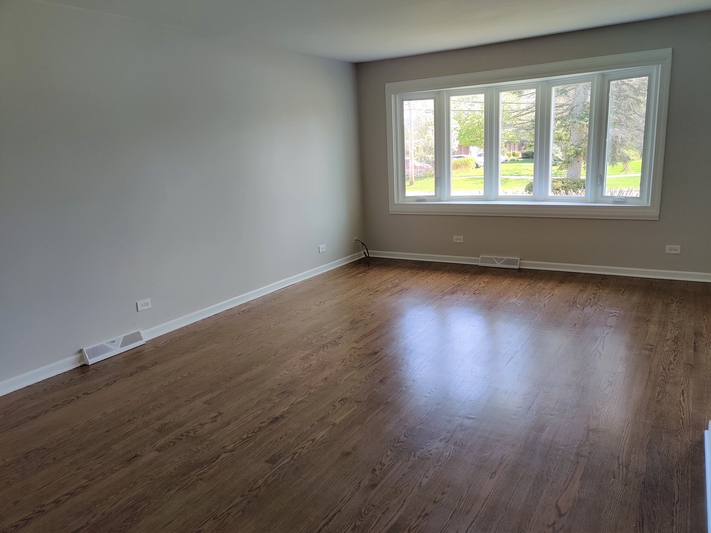 4324 Cumnor Road Downers Grove, IL 60515 - Photo 2 of 12 a view of an empty room with wooden floor and a window