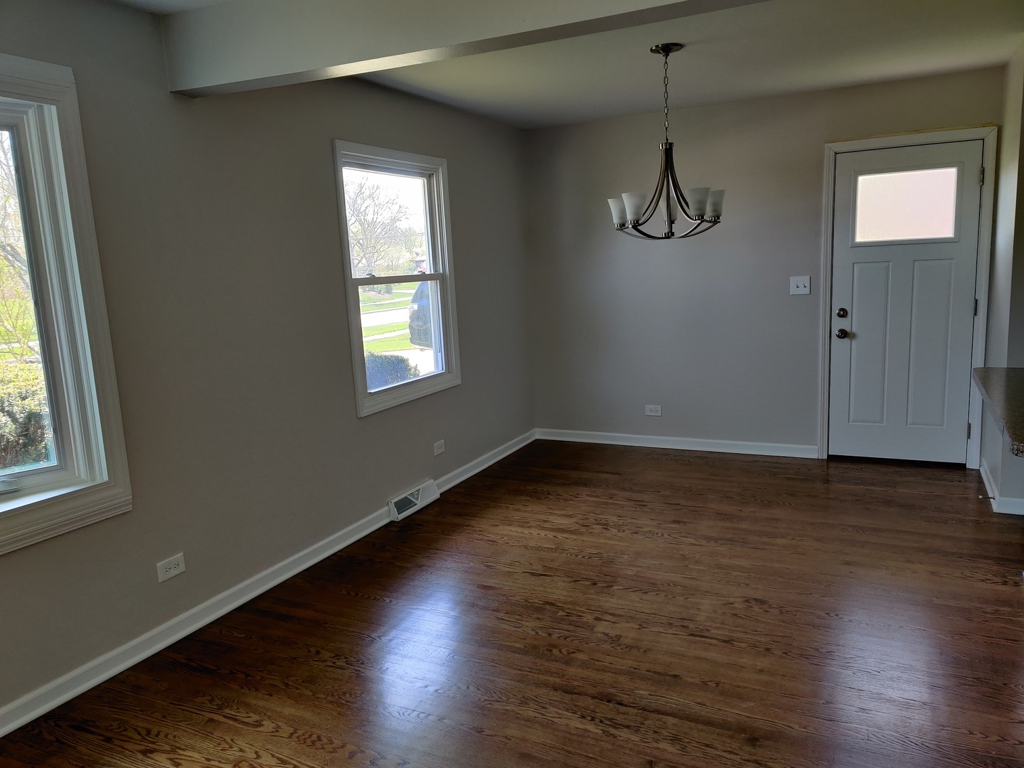 4324 Cumnor Road Downers Grove, IL 60515 - Photo 4 of 12 an empty room with wooden floor and windows
