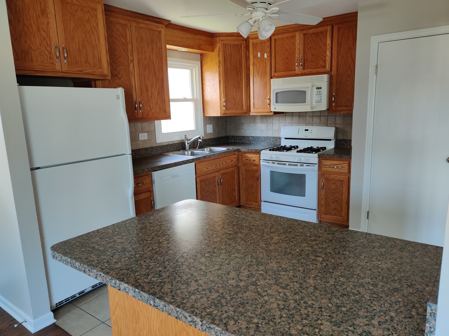 4324 Cumnor Road Downers Grove, IL 60515 - Photo 5 of 12 a kitchen with stainless steel appliances granite countertop a sink stove and refrigerator