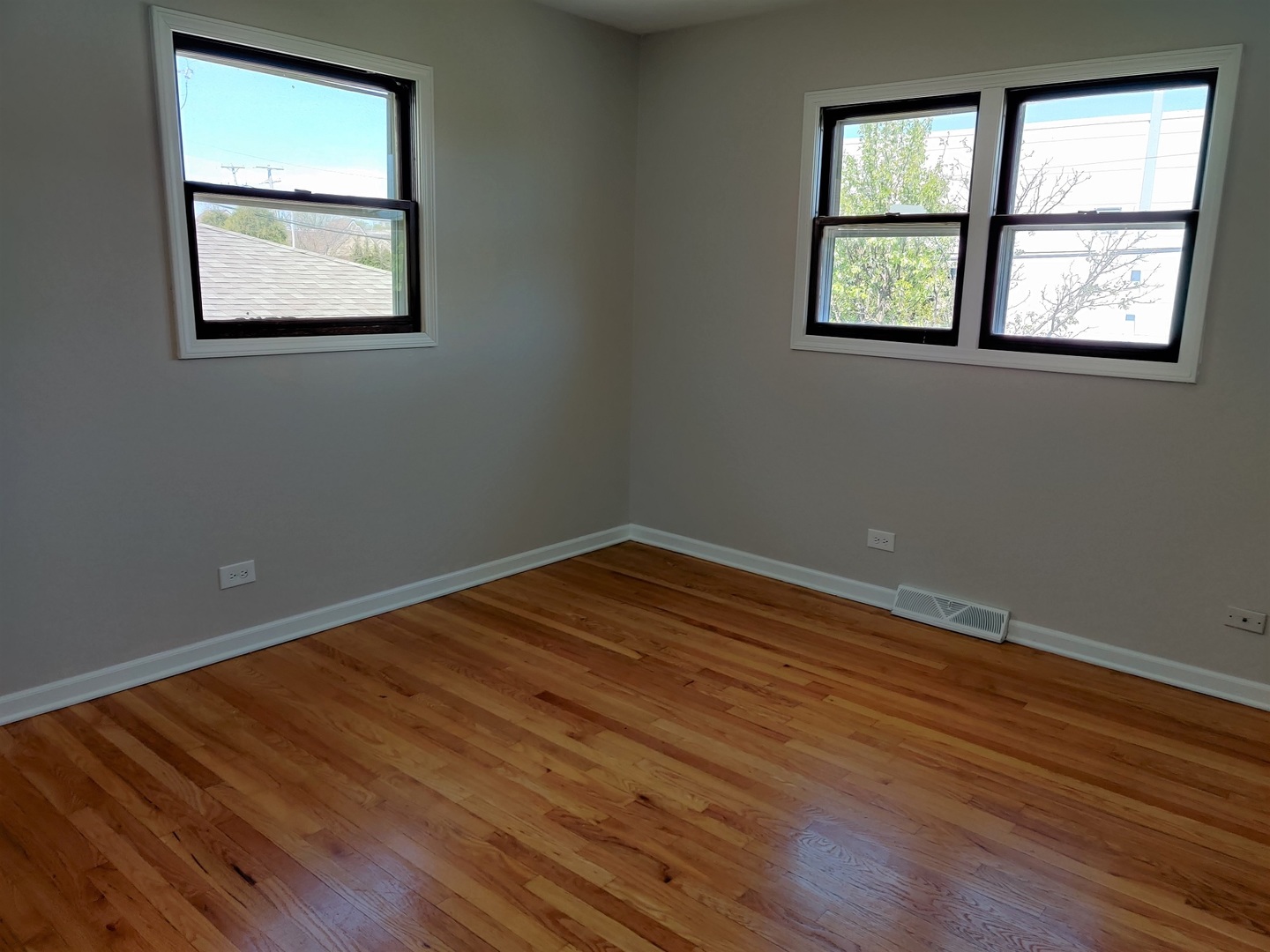4324 Cumnor Road Downers Grove, IL 60515 - Photo 7 of 12 an empty room with wooden floor and windows