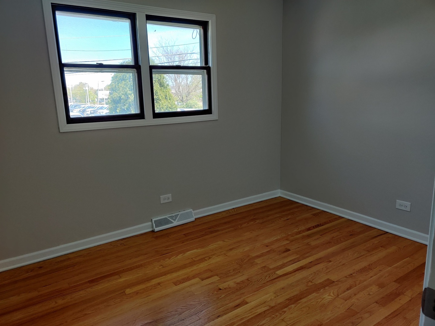 4324 Cumnor Road Downers Grove, IL 60515 - Photo 8 of 12 an empty room with wooden floor and windows
