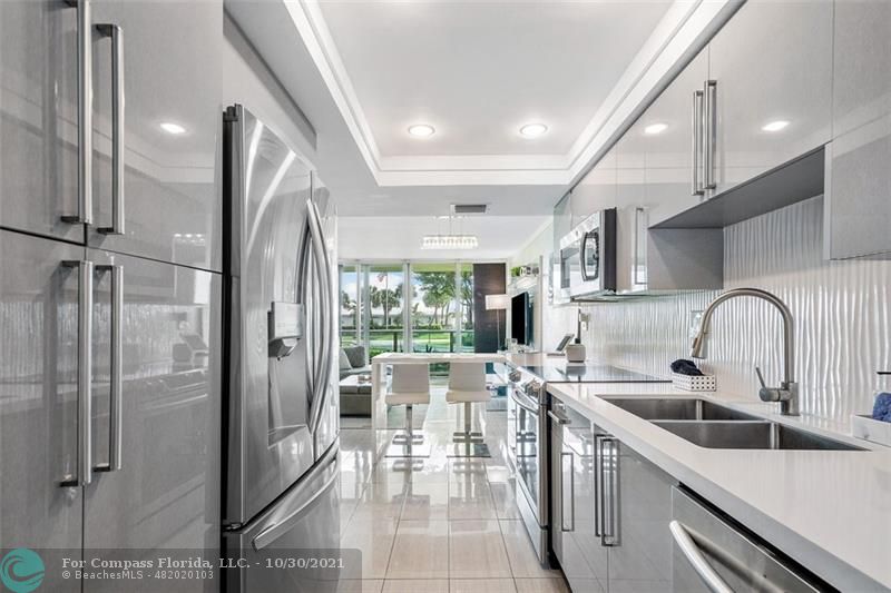 a kitchen with stainless steel appliances a sink stove and a refrigerator